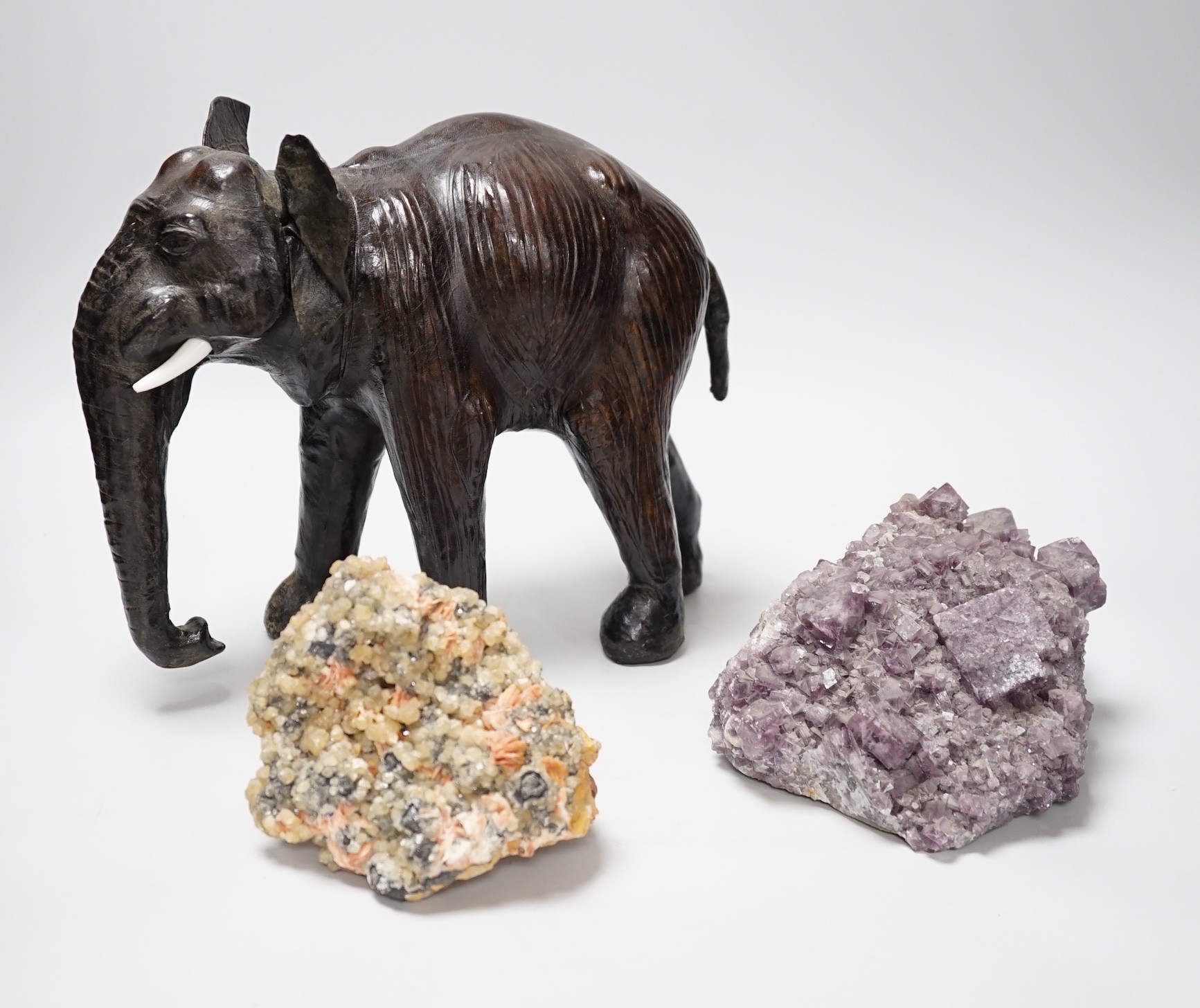 Two specimens; amethyst and rock crystal, and a leather model of an Indian elephant, 24cm high